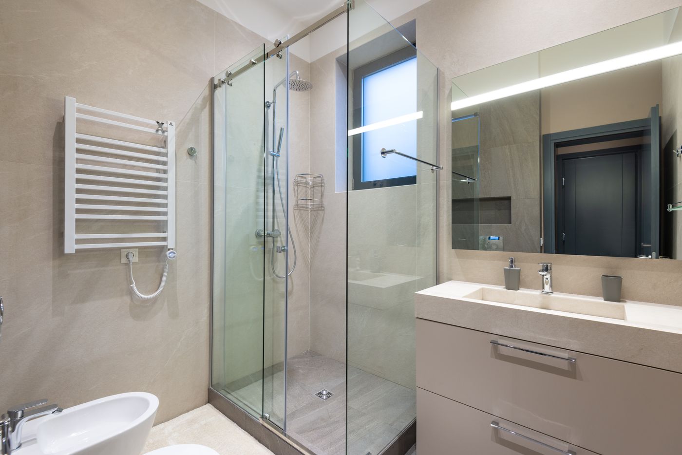 Bathroom with glass shower enclosure and vanity with working clearances