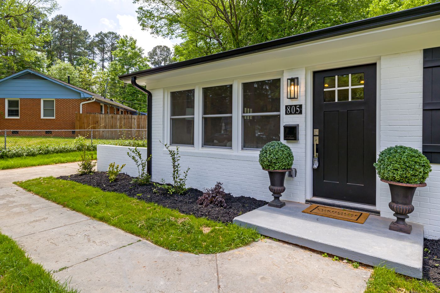 Home front entry with walkway, landing and updated exterior finishes